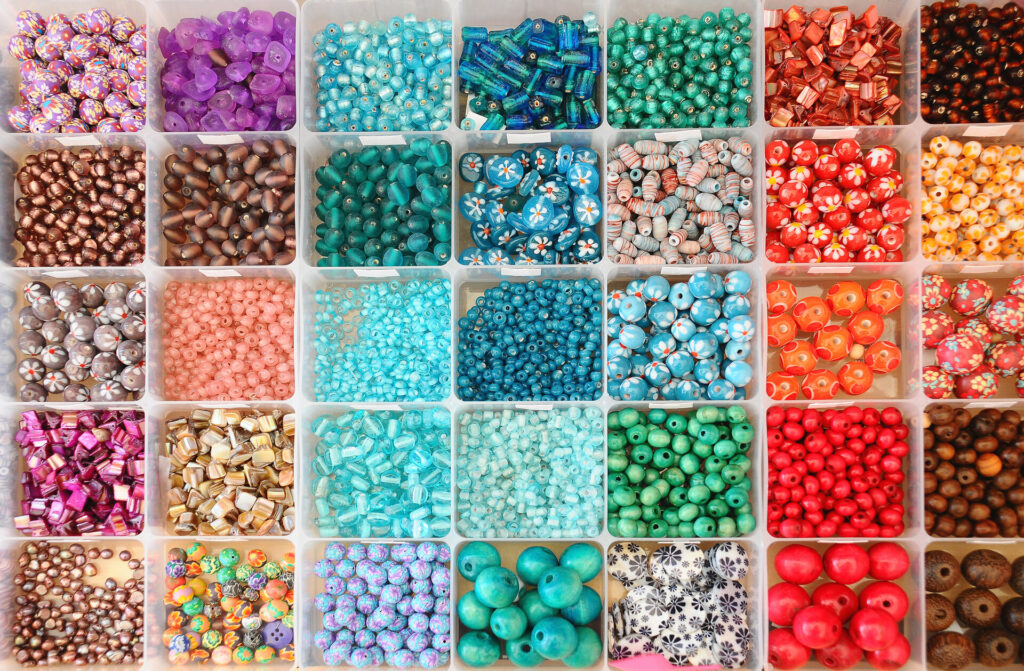 Large collection of colourful beads in boxes